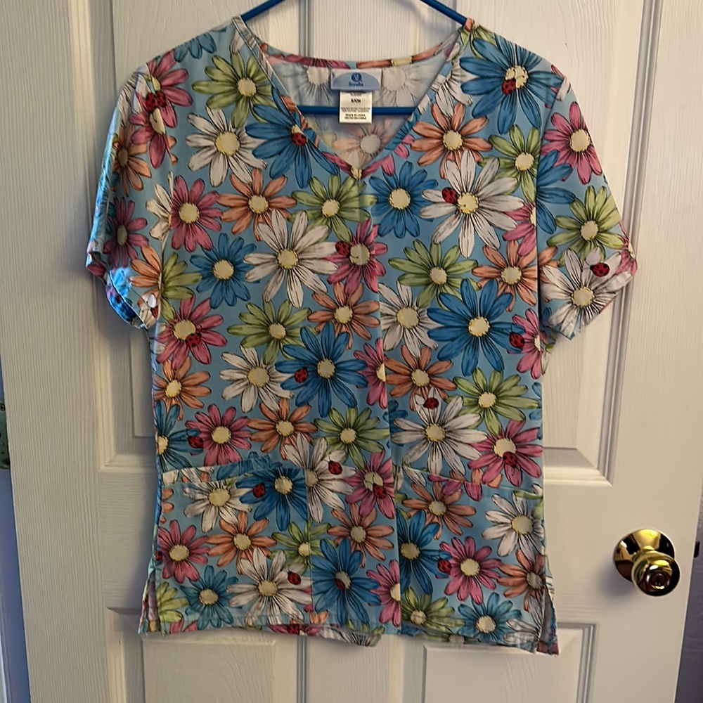 Springy scrub top with darling daisies and  ladybugs running around.